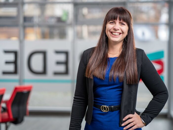 Janine Richter, Datenschutz Expertin bei BREDEX, eine weiße Frau mit langen braunen Haaren.